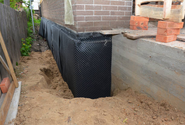 Happy homeowners after waterproofing job in Auburn University